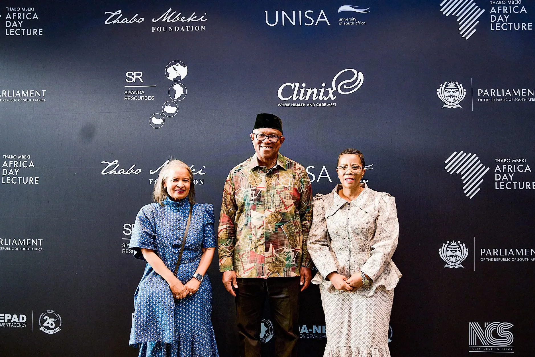 Peter Obi standing between two women in front of a Thabo Mbeki Foundation Africa Day Lecture backdrop