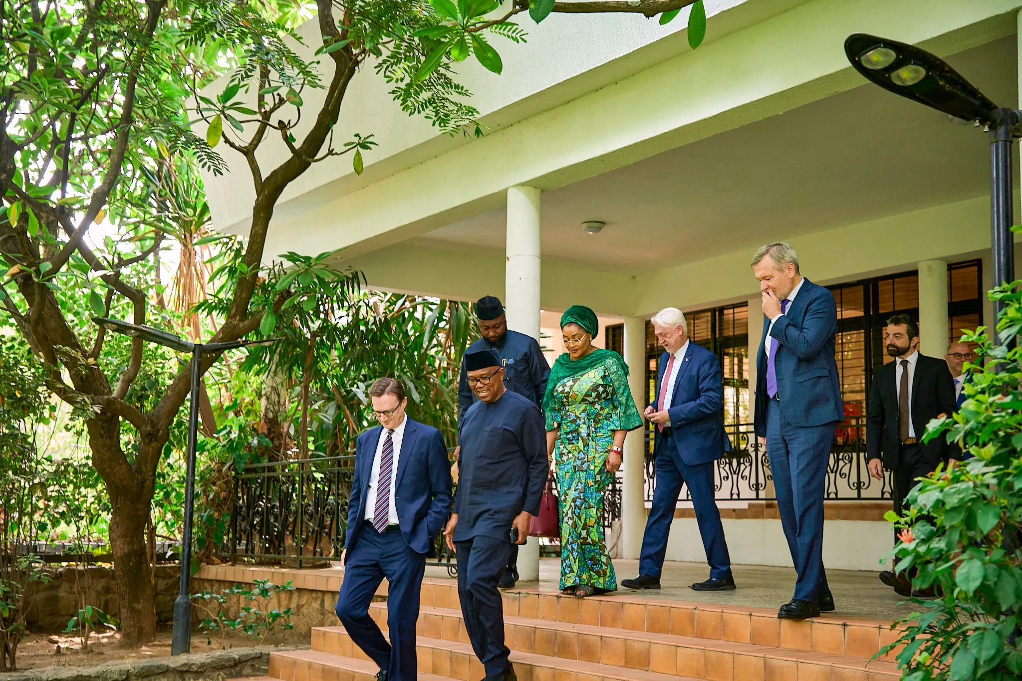 Peter Obi at the top of a flight of steps as a visiting delegation walks down into a garden