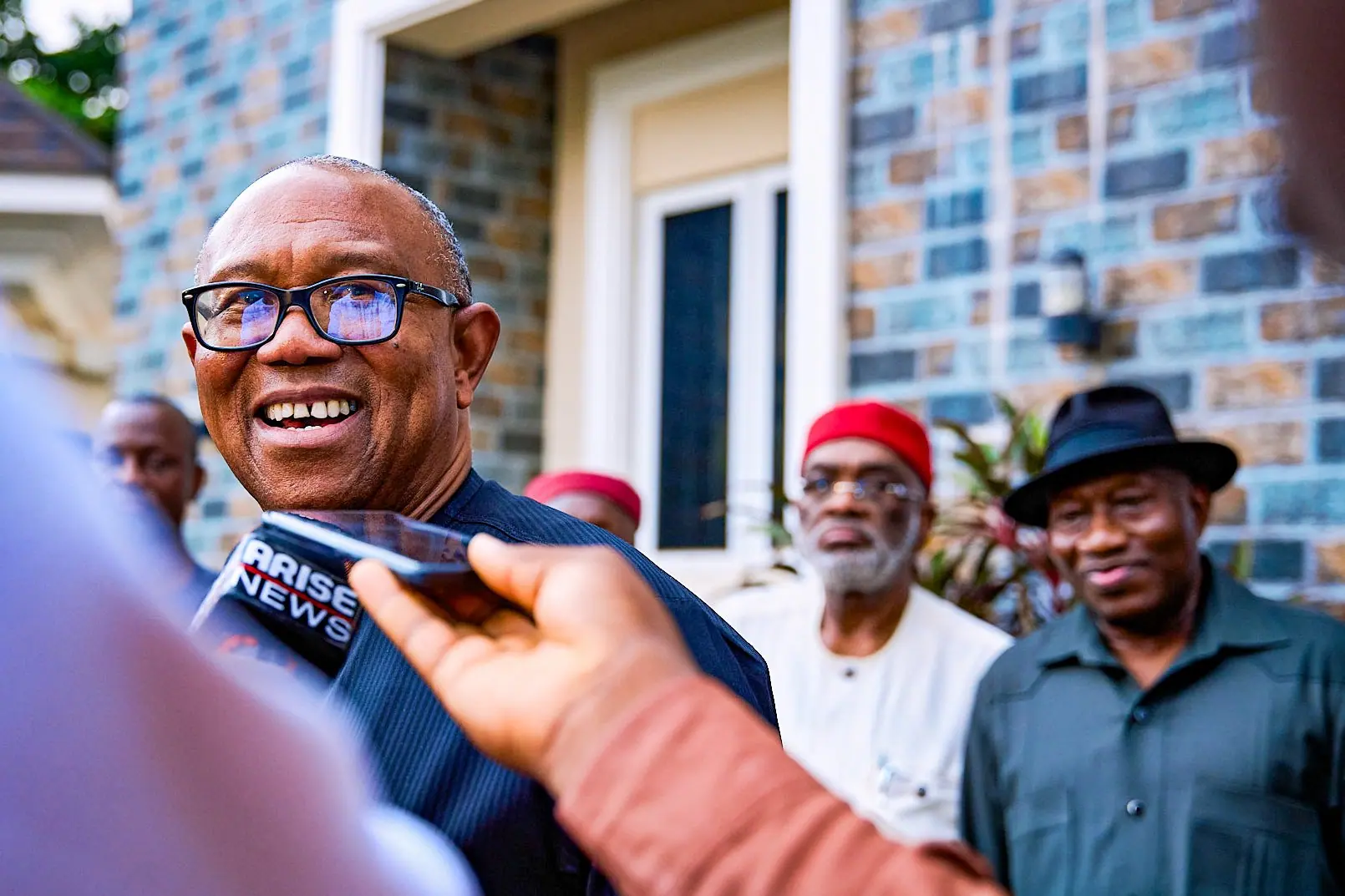 Peter Obi smiling into an Arise News microphone held towards him outdoors