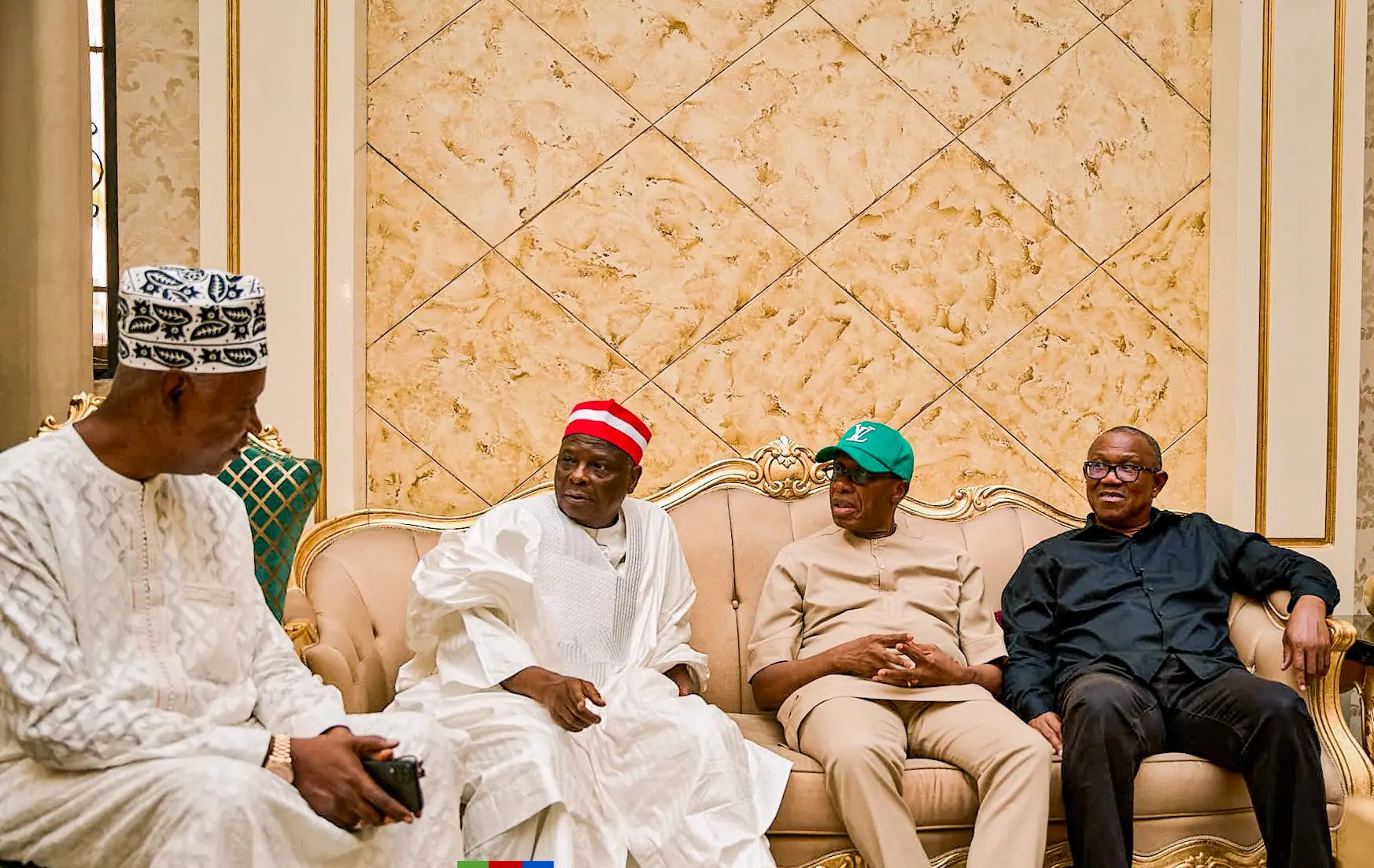 Peter Obi seated with three hosts on gilt chairs in a reception room