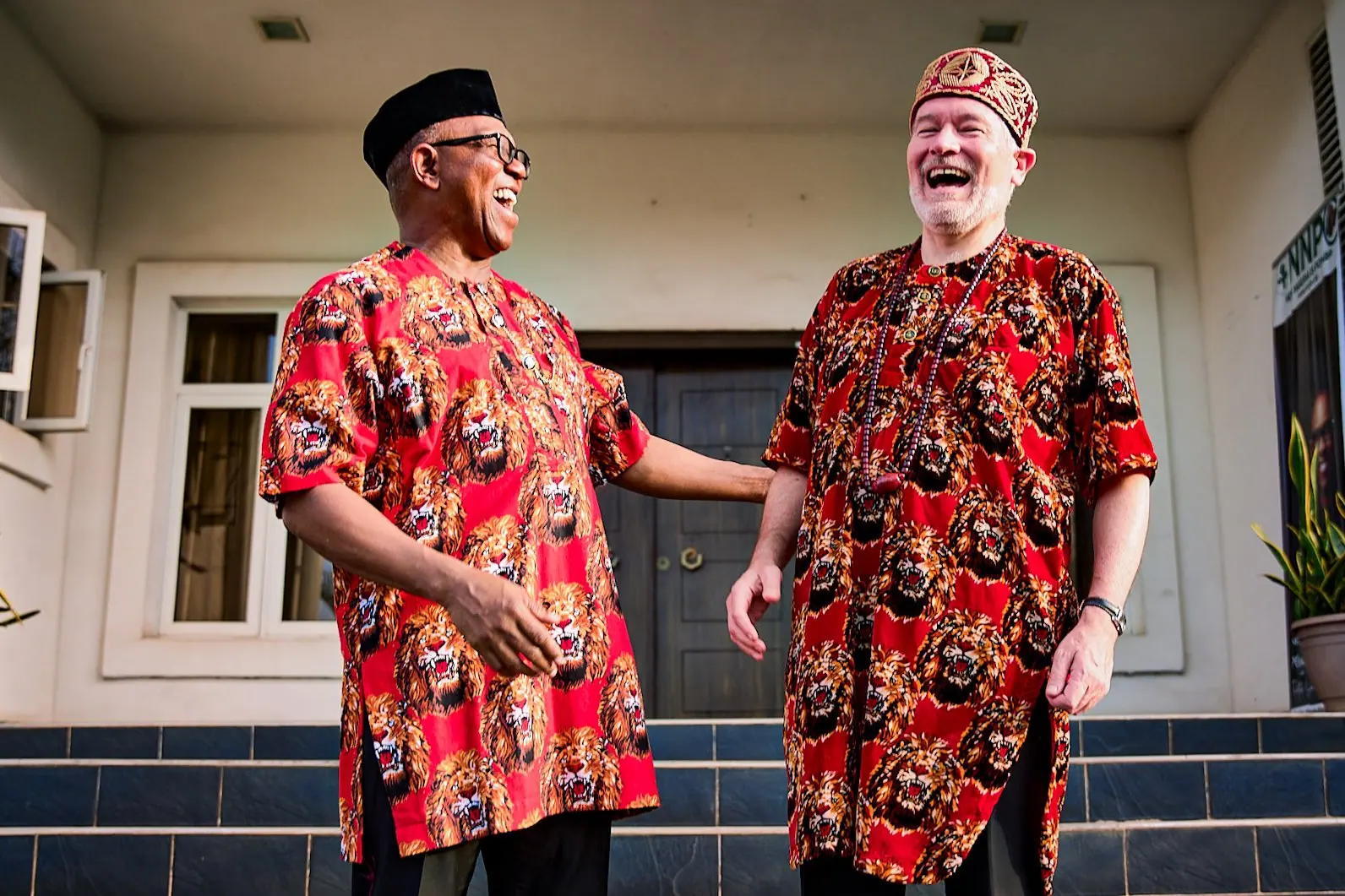 Peter Obi and the European Union Ambassador Gautier Mignot laughing, both wearing the same red Igbo print shirt