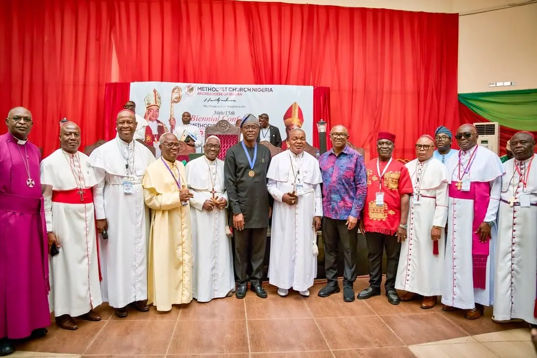 Peter Obi standing in a line of Methodist bishops in white and red vestments