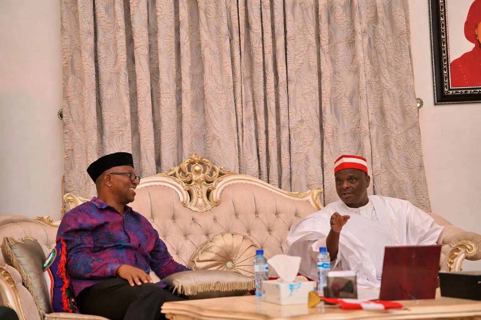 Peter Obi seated in an ornate reception room in conversation with one other man