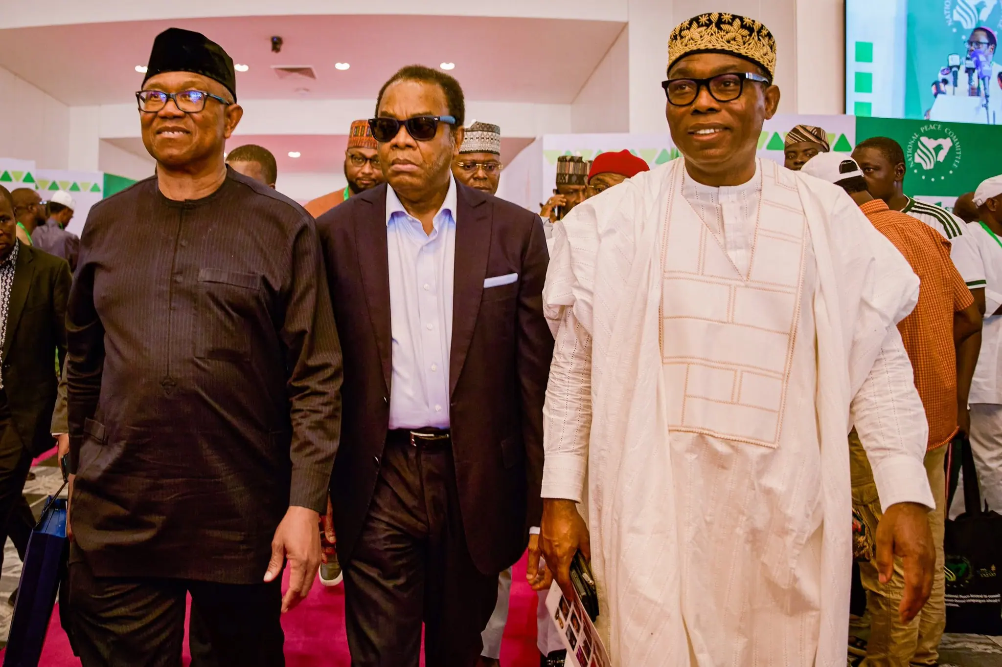 Peter Obi walking in on a red carpet with Donald Duke and Adewole Adebayo