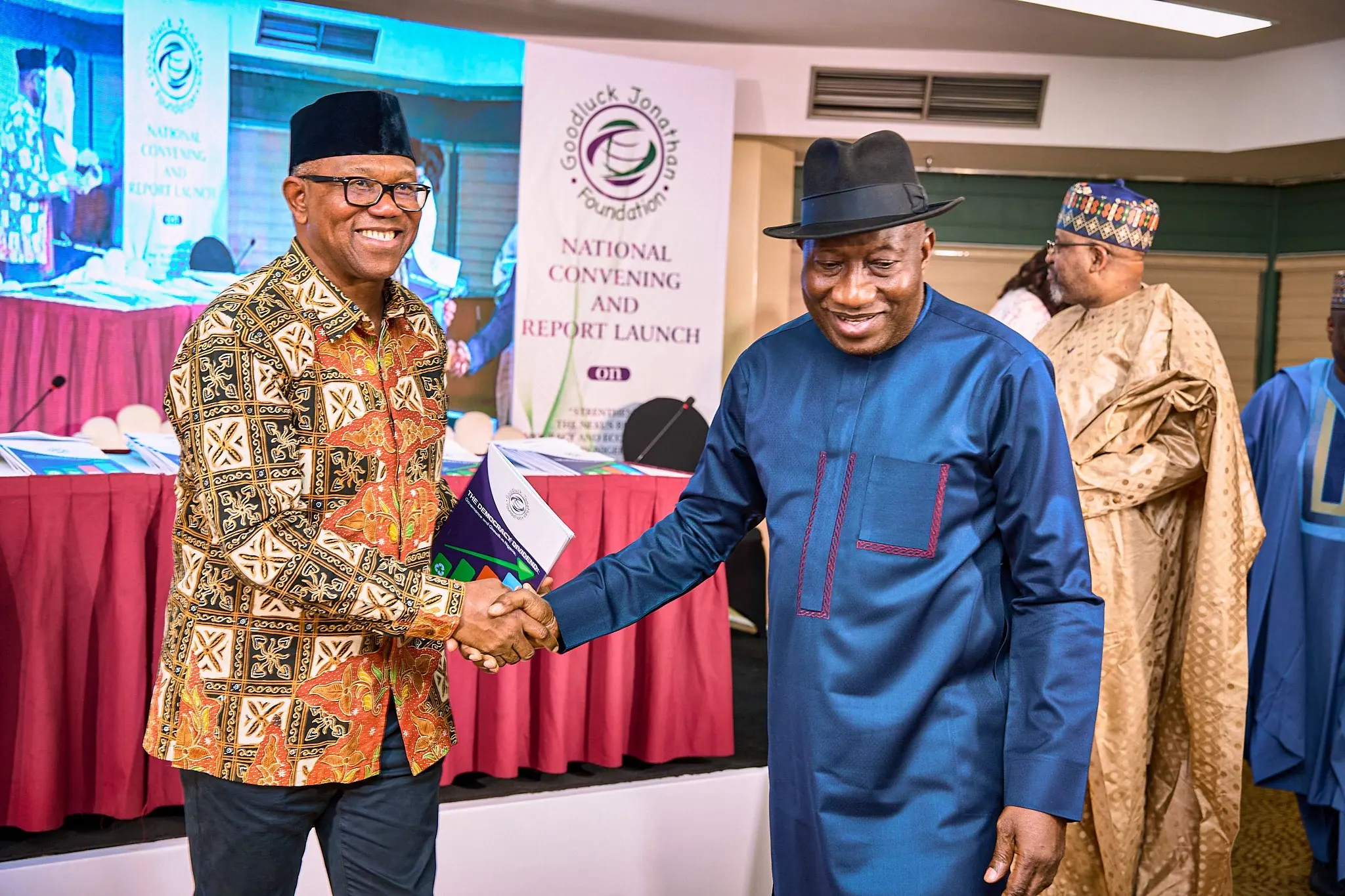 Peter Obi shaking hands with Goodluck Jonathan at a National Convening and Report Launch