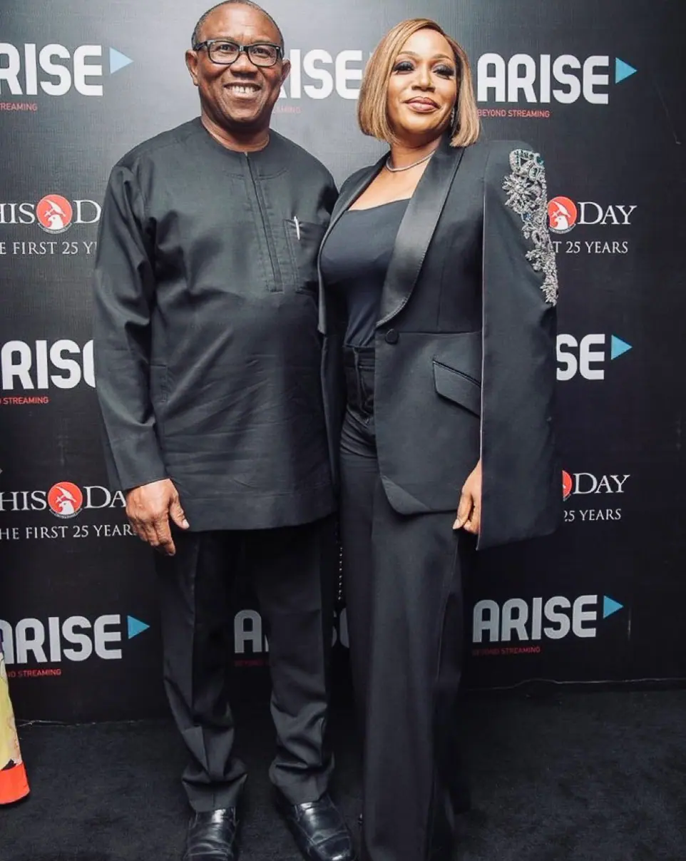 Peter Obi and his wife Margaret Obi in front of a ThisDay and Arise step-and-repeat banner