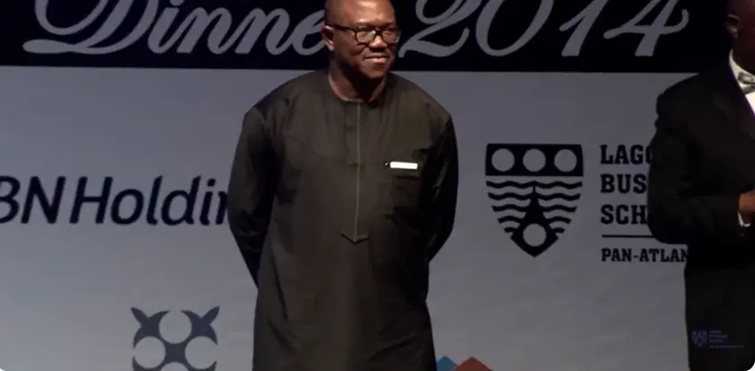 Peter Obi standing on stage at the Lagos Business School President's Dinner while his citation is read